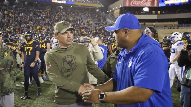 Nov 4, 2023; Morgantown, West Virginia, USA; West Virginia Mountaineers head coach Neal Brown speaks to Brigham Young Cougars head coach Kalani Sitake after the game at Mountaineer Field at Milan Puskar Stadium.